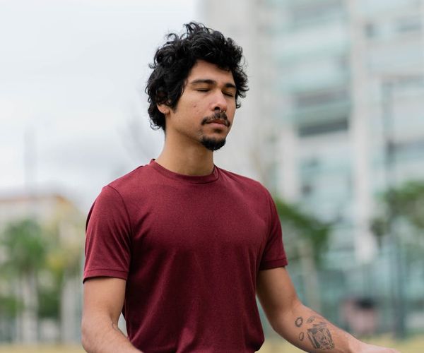 Man sitting in a calm, focused state after an exercise session.